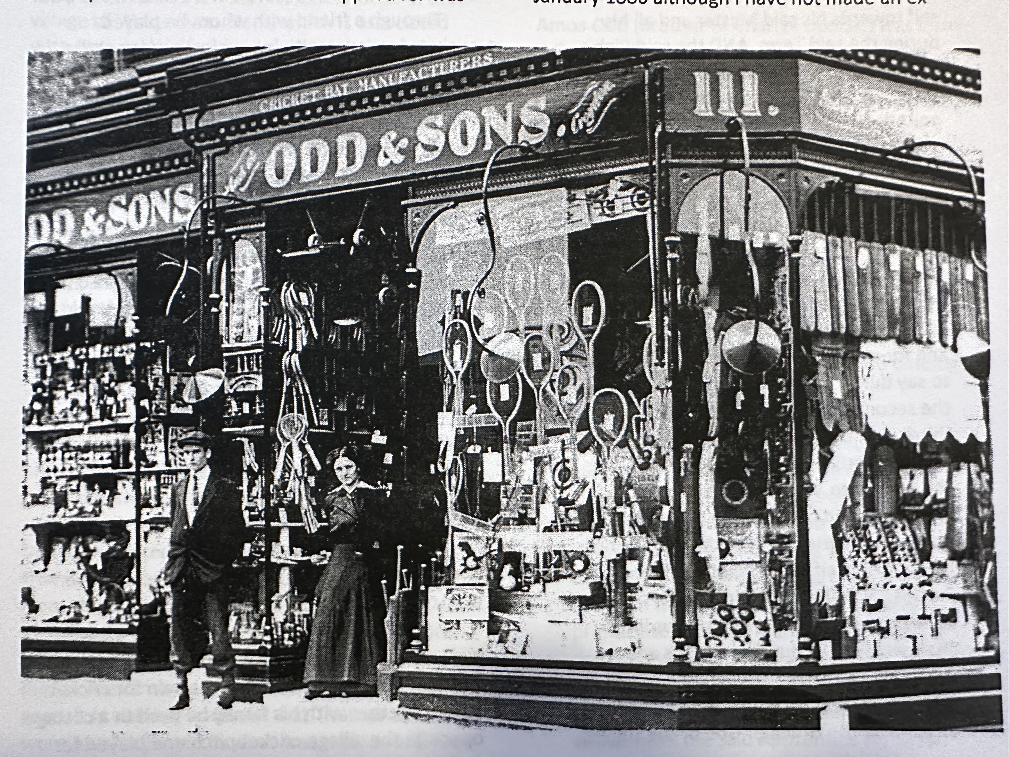 Historical photograph of the Odd and Sons sporting-goods shopfront, with cricket bats and racquets on display